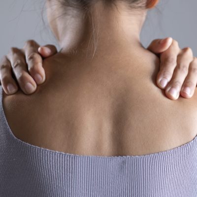 Asian woman has shoulder pain. Female holding painful shoulder with another hands. People with body-muscles problem, Healthcare And Medicine.